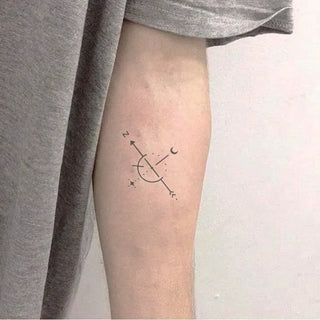 Minimalist one-line compass tattoo.