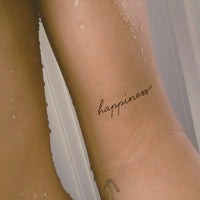 Happiness writing tattoo