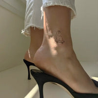 Dinosaur turtle tattoo on a skateboard