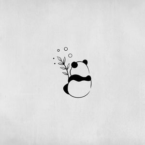 Panda tattoo eating a leaf