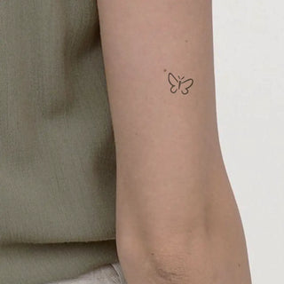 Minimalist one-line little butterfly tattoo.