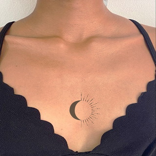 Crescent moon tattoo with dotted pattern.